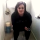 A cute British girl is video-recorded by her friend as she shits while sitting on a toilet. There are no pooping sounds, but a few good peeks and some comments about the aroma in the bathroom.
